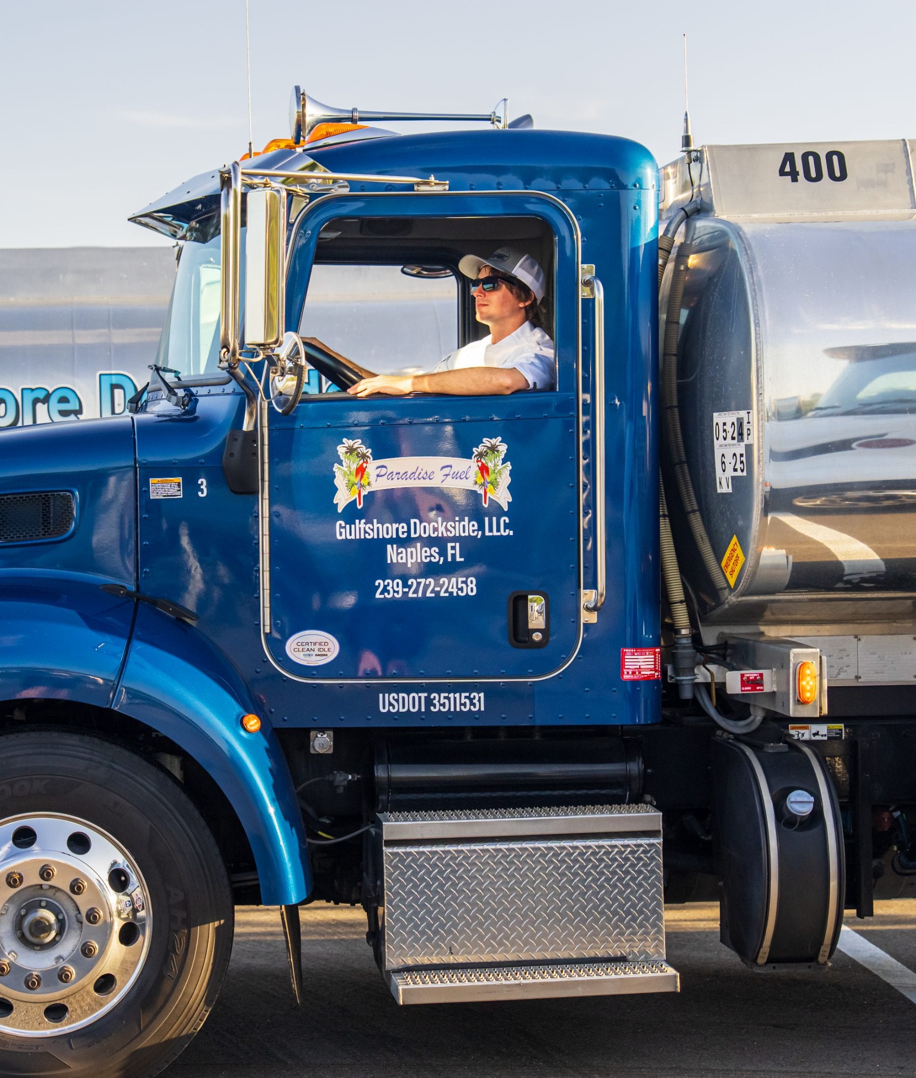 A Gulfshore Dockside driver at the wheel of the blue Paradise Fuel tanker, Naples, Florida