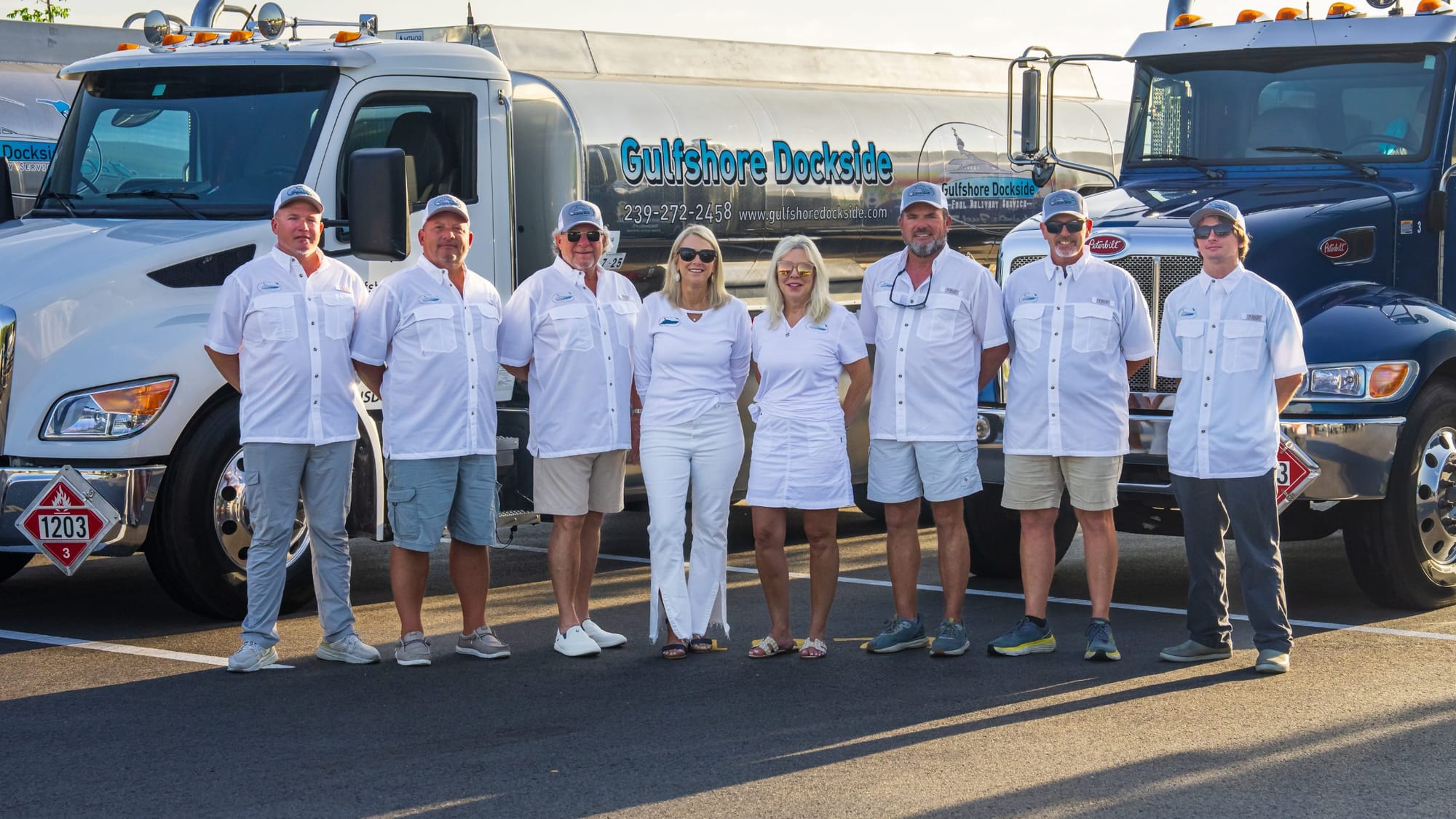 The eight-person Gulfshore Dockside crew in front of the lettered tankers, Naples, Florida
